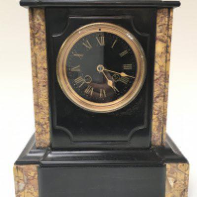 A black slate and marble mantle clock with key, 28cm tall 25cm wide. This lot cannot be posted