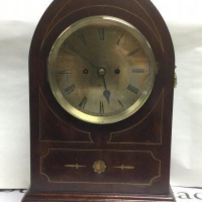 An eight day inlaid mahogany arch top mantle clock, approx height 51cm. Shipping category D.