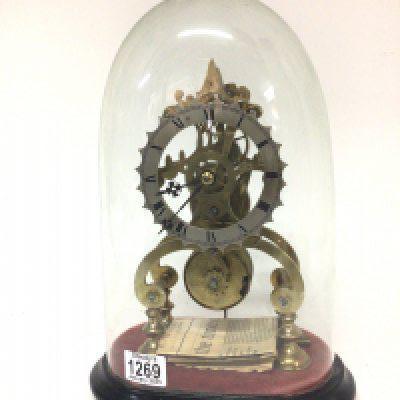 A quality single fusee skeleton clock under a glass dome with key and pendulum no obvious damage height of dome 37cm