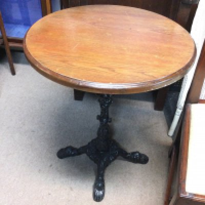 A wrought iron table. 59cm diameter top and 71cm tall.