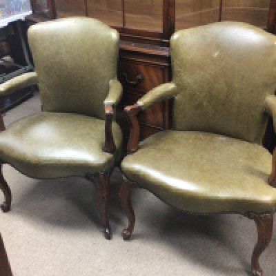 A pair of quality George III style mahogany open arm chairs.upholstered in green faux leather with shaped legs and scroll arms. Good condition (2)