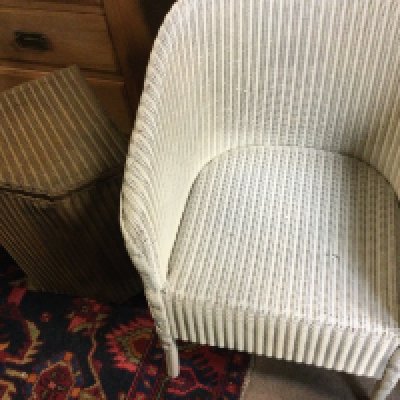 A Lloyd loom basket and a wicker chair.