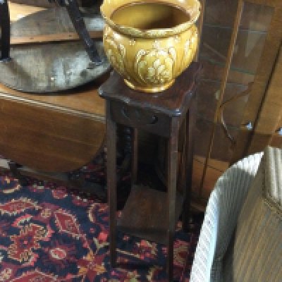 A plant pot stand and a ceramic pot.