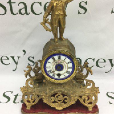 A French gilt ormolu mantle clock with painted enamel dial and with a finely dressed gentleman to the top, approx height 36cm. Shipping category D.
