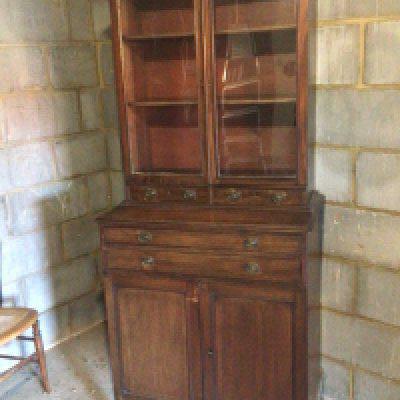 An Early 19th century late Regency Mahogany cabinet with glazed doors above small drawers and cupboards. 180cm heigh 80cm wide approximately.