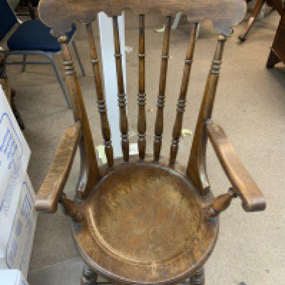 A large spindle back Windsor armchair.