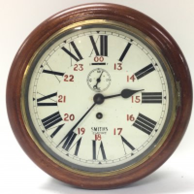 A Smiths wall clock, with key. Clock 26cm wide. Seen working. This lot cannot be posted