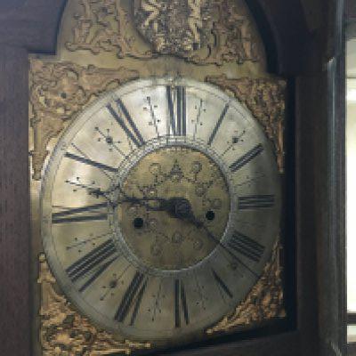 A oak 8 day long case clock the arched brass dial with Roman numerals. No reserve.