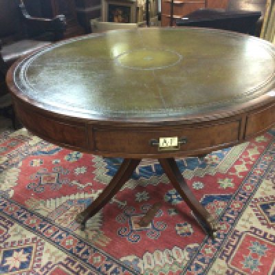 A George III style Mahogany Rent table the circular top with green leather above drawers with applied alphabet markets on a turned column and splayed legs top diameter 122cm