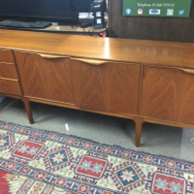 A Mid 20th century Teak sideboard fitted with cupboards and drawers.