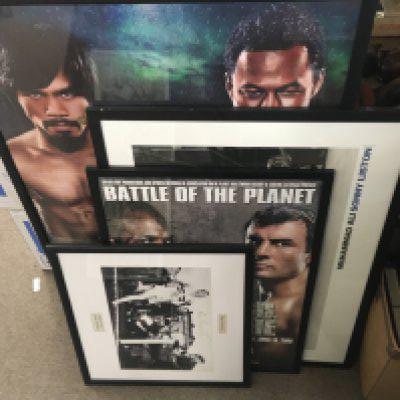 Framed sports memorabilia including boxing posters, signed Roger Bannister photo etc.This lot cannot be posted