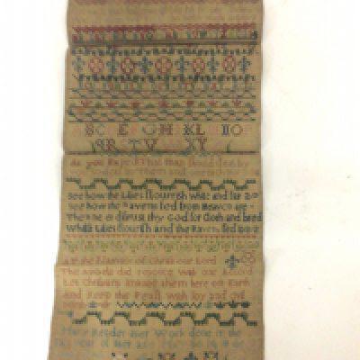 A mid 18th century needlework sampler dated 1743 by Mary Reader aged 14 the detailed needlepoint with alphabet and script verses and floral patterns. 20x44cm