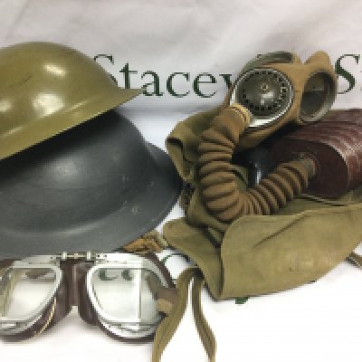 An RAF jacket, two helmets, flying goggles, binoculars and a gas mask. Shipping category D.