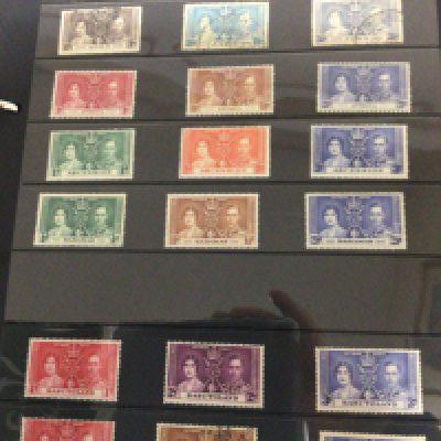 Four Green Alpha Major albums containing a well presented in sleeved pages good selection of used and some unused George VI stamps from Queen Victoria to Elizabeth II an album of Ceylon India Kenya Malta and many other British colonies and Empire stamps and other world stamps (4)