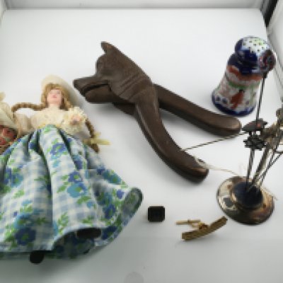 An assorted lot including silver hat pin stands and several hat pins vintage nut cracker dolls etc. Postage B