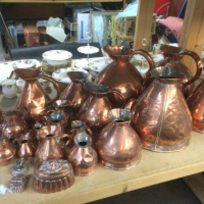 A large collection of antique copper jugs, measures, jelly moulds etc. Shipping category D.
