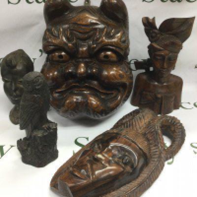 Two boxes of carved wooden and resin figures and masks etc. Shipping category D.