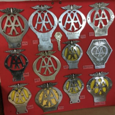 A collection of 12 vintage AA car badges from 1911, postage category B
