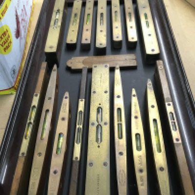 16 vintage brass spirit levels all mounted on framed display, this lot cannot be posted