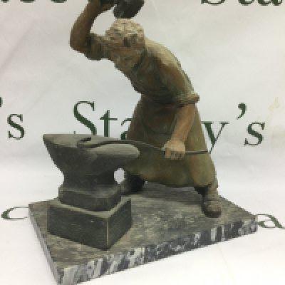 A spelter figure of a blacksmith, approx height 27cm. Shipping category D.
