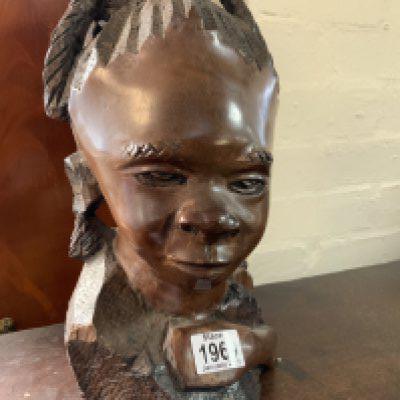 An African carved hardwood sculpture of a child, 32cm.