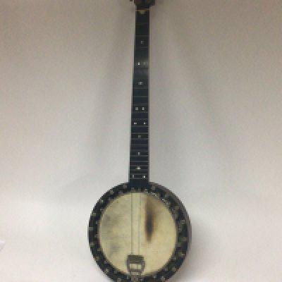 A vintage banjo with enclosed back with a case