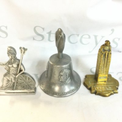 An aluminium Churchill Victory bell and a chrome Britannia along with a brass Canada trench art memorial cenotaph. Postage b