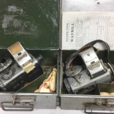 Two vintage bus conductor's ticket machines, one manufactured by TIM of Cirencester plus one other. Both housed in original carry cases. Shipping category D.