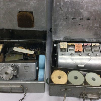 Two vintage bus conductor's ticket machines in original carry cases with rolls of unused tickets (2). Shipping category D.