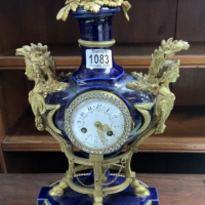 A 19th century French Louis XVI style Sevres porcelain and ormolu mantel clock. Heavily restored example.