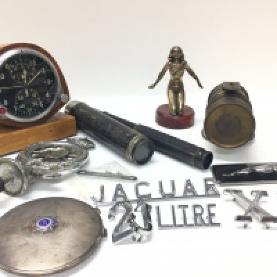 A collection of items including a Russian Chronograph clock, Silver hallmarked compact mirror with RASC enamel badge, bronze nude lady car mascot, RAC mascot, jaguar badges, monoculars. This lot cannot be posted