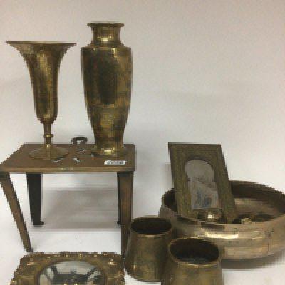 A collection of antique and later brass ware including Middle Eastern vases and a bed pan and other ornaments.