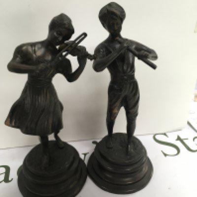 A pair of bronzed figures playing musical instruments. 26 cm