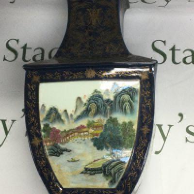 A Chinese vase with extensive giltwork decoration on a dark blue ground and having panels decorated with typical landscape scenes and Oriental script. Approx height 48cm. Shipping category D.