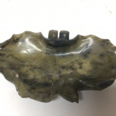 A Chinese spinach jade dish of naturalist form a shaped lotus leaf possible early 20th century. 13x9cm no reserve