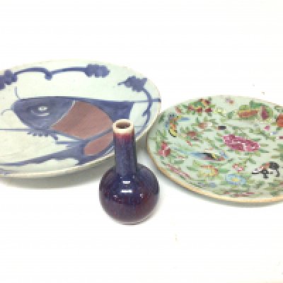 A Chinese red glazed small bottle vase with caricature marks to the base a 19th century Celadon dish and an Eport porcelain dish decorated with a Carp fish. (3)