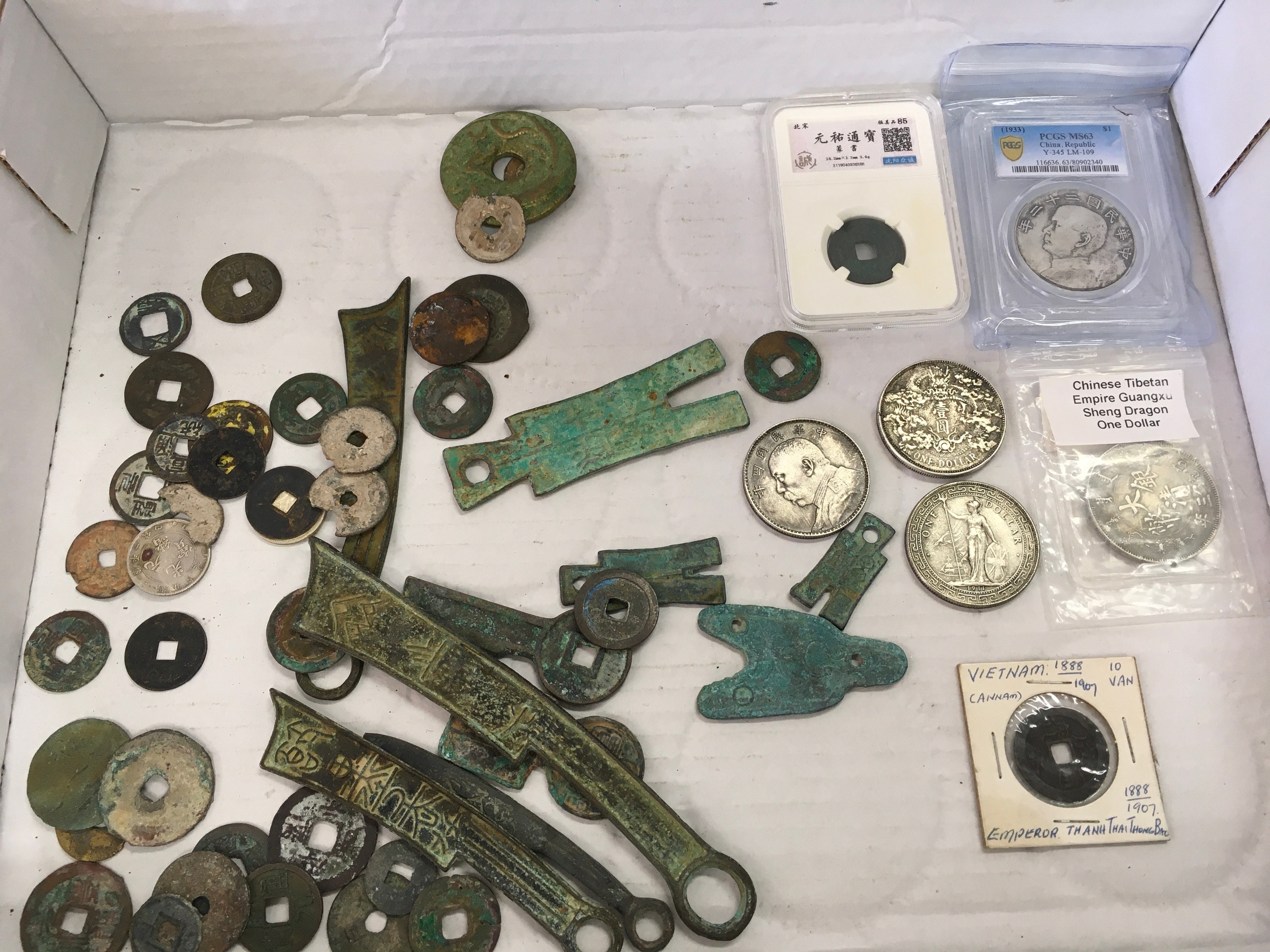 Approximately 55 Chinese and Vietnamese antique cash and sword coins including Ming and Chinese republic periods 