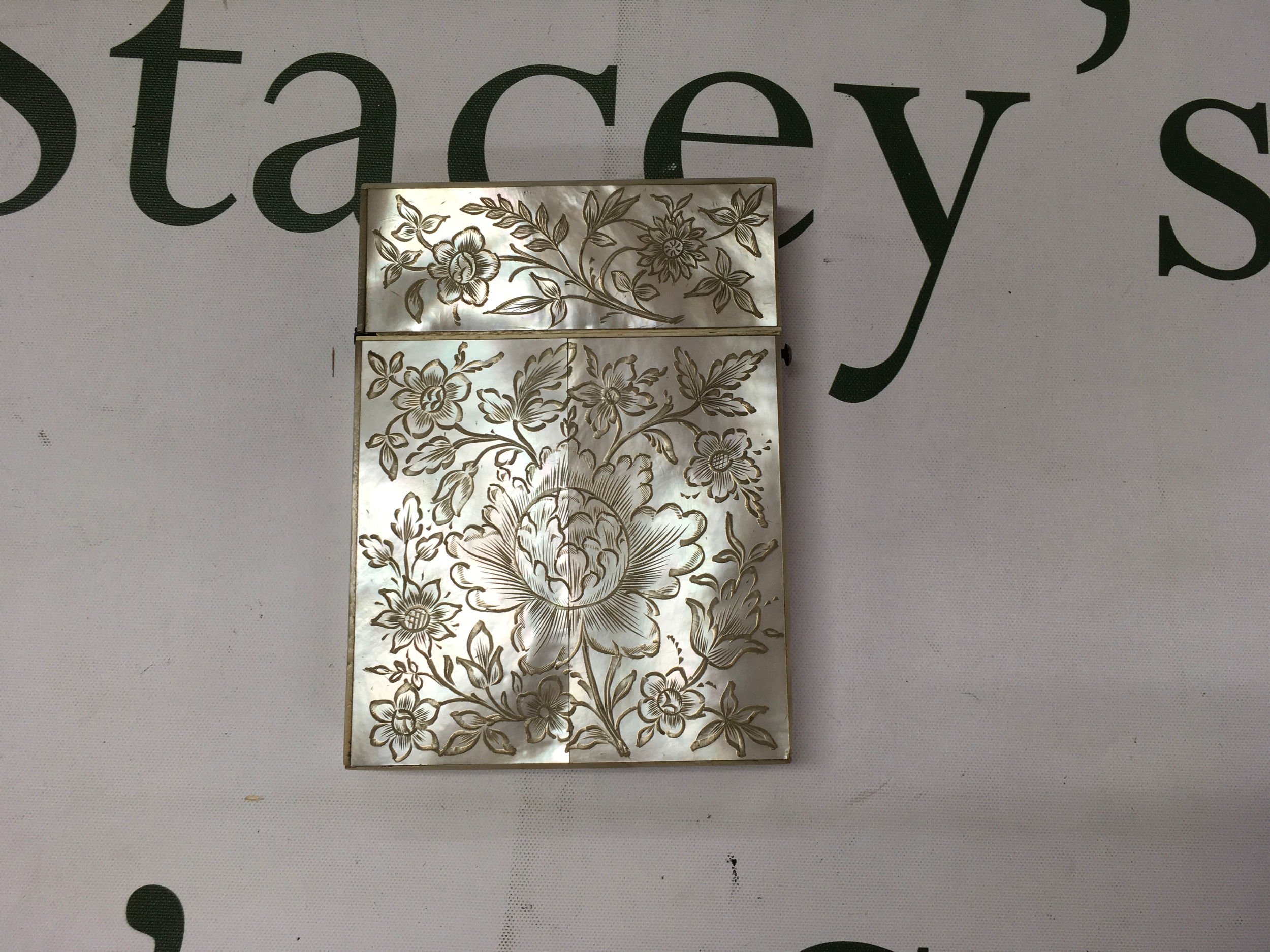 A Victorian era hand engraved mother of pearl calling card case.