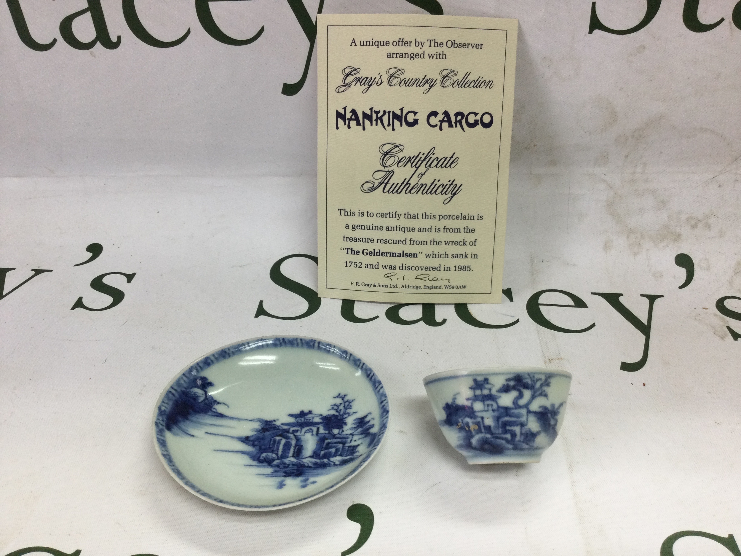 NanKing cargo cup and saucer. With certificate d stickers to base at Christies lot number 5107  cup and saucer depicts house Under tree.no damage.