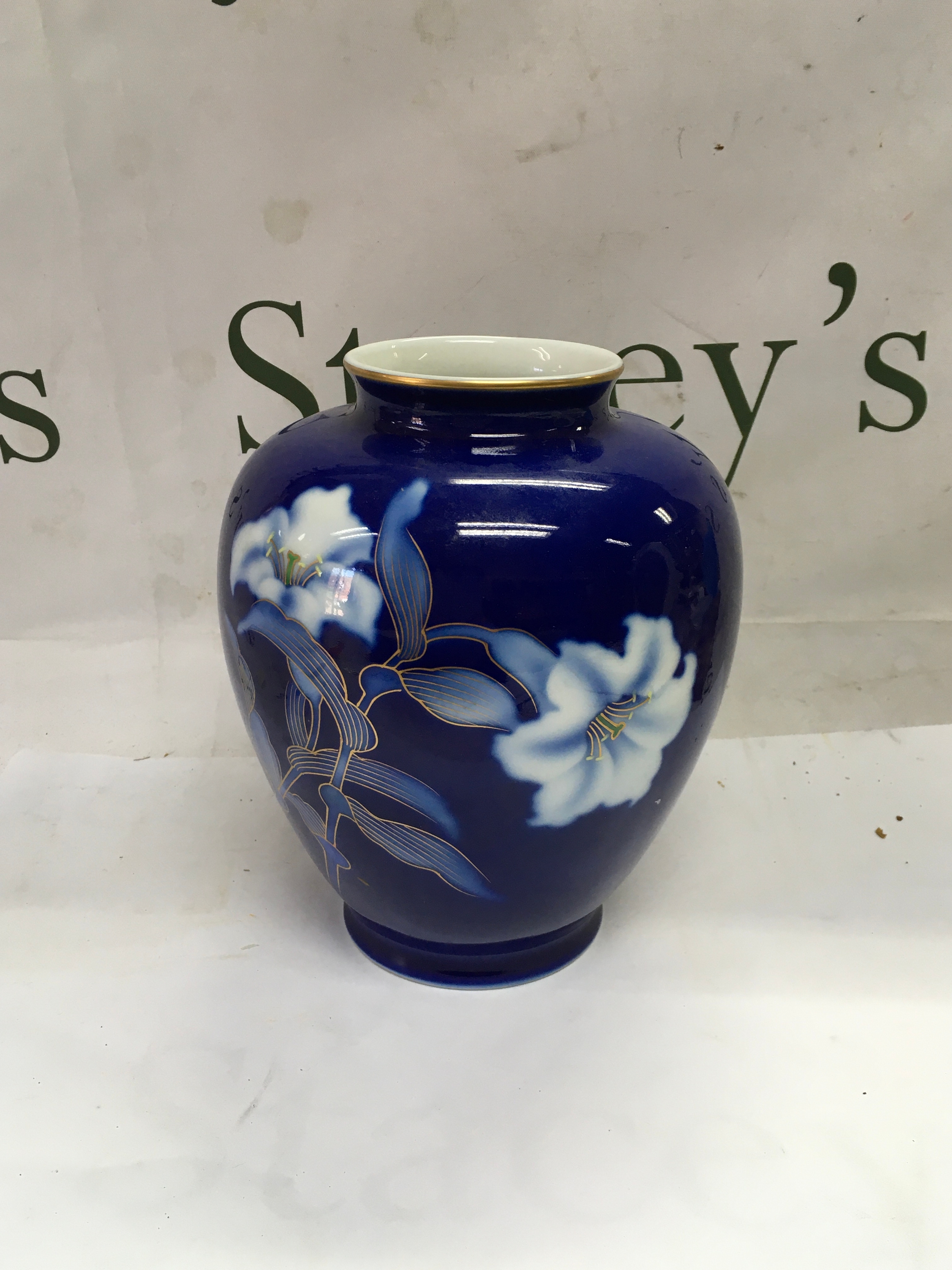 A pair of ceramic Japanese vases including one satsuma ware vase and a cobalt blue porcelain vase. 