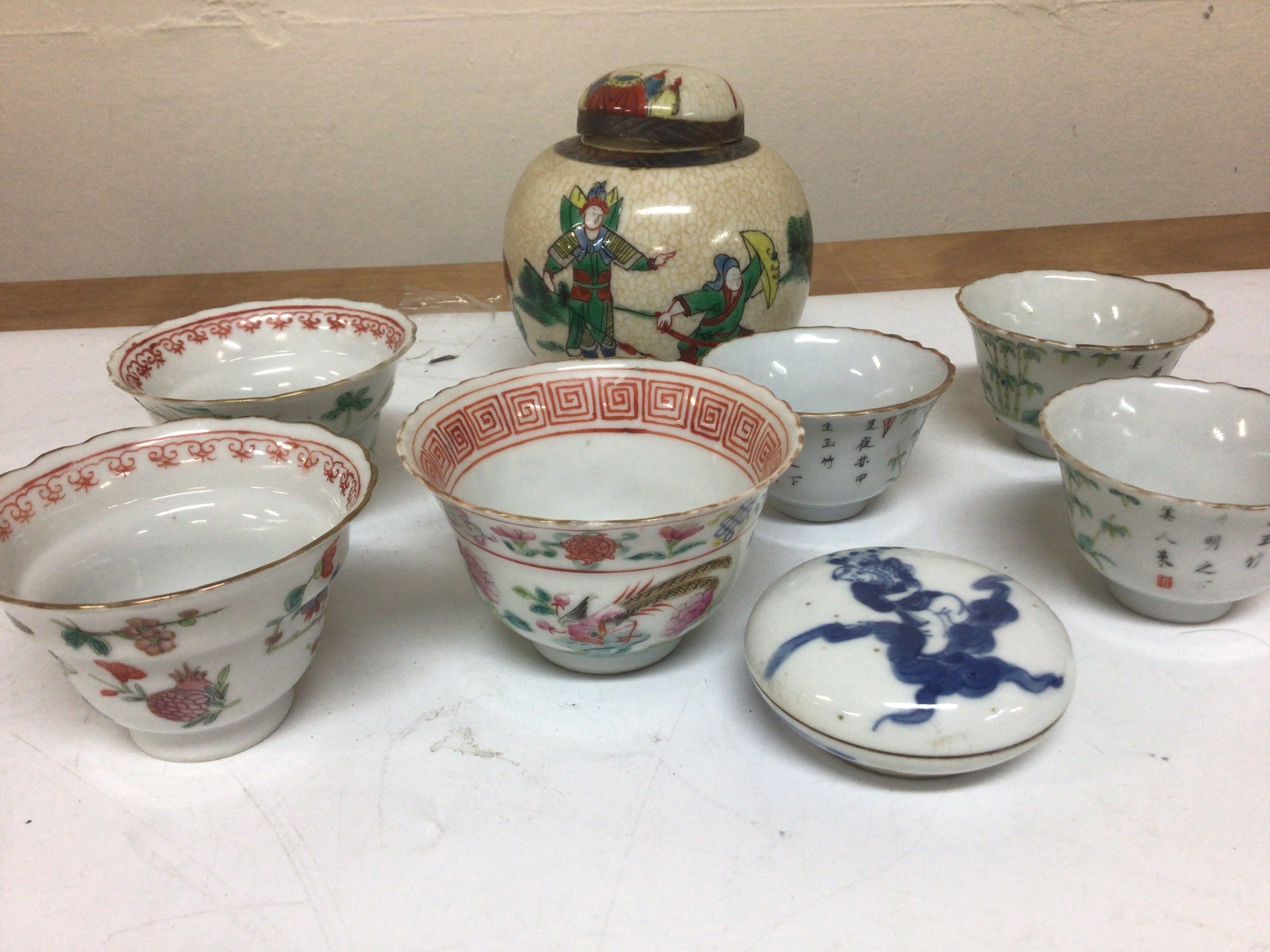 A Collection of Chinese porcelain tea bowls Republic period a crackle ware ginger jar and cover and a small Chinese blue and white round dish and cover with caricature marks to the base.