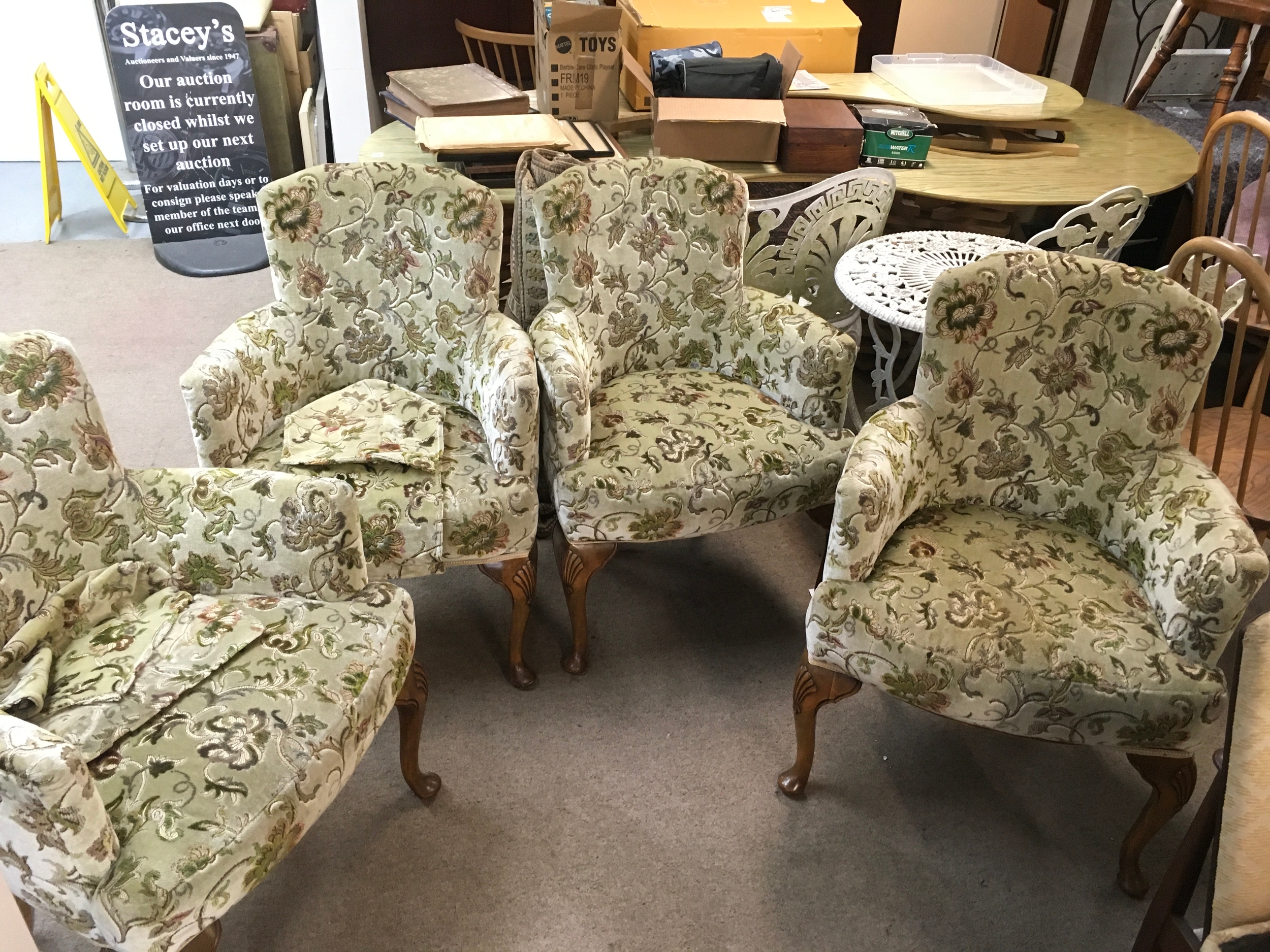 Four matching Victorian-style armchairs featuring light green floral upholstery and carved wooden cabriole legs. . 93cm tall 65cm wide , 50cm long
