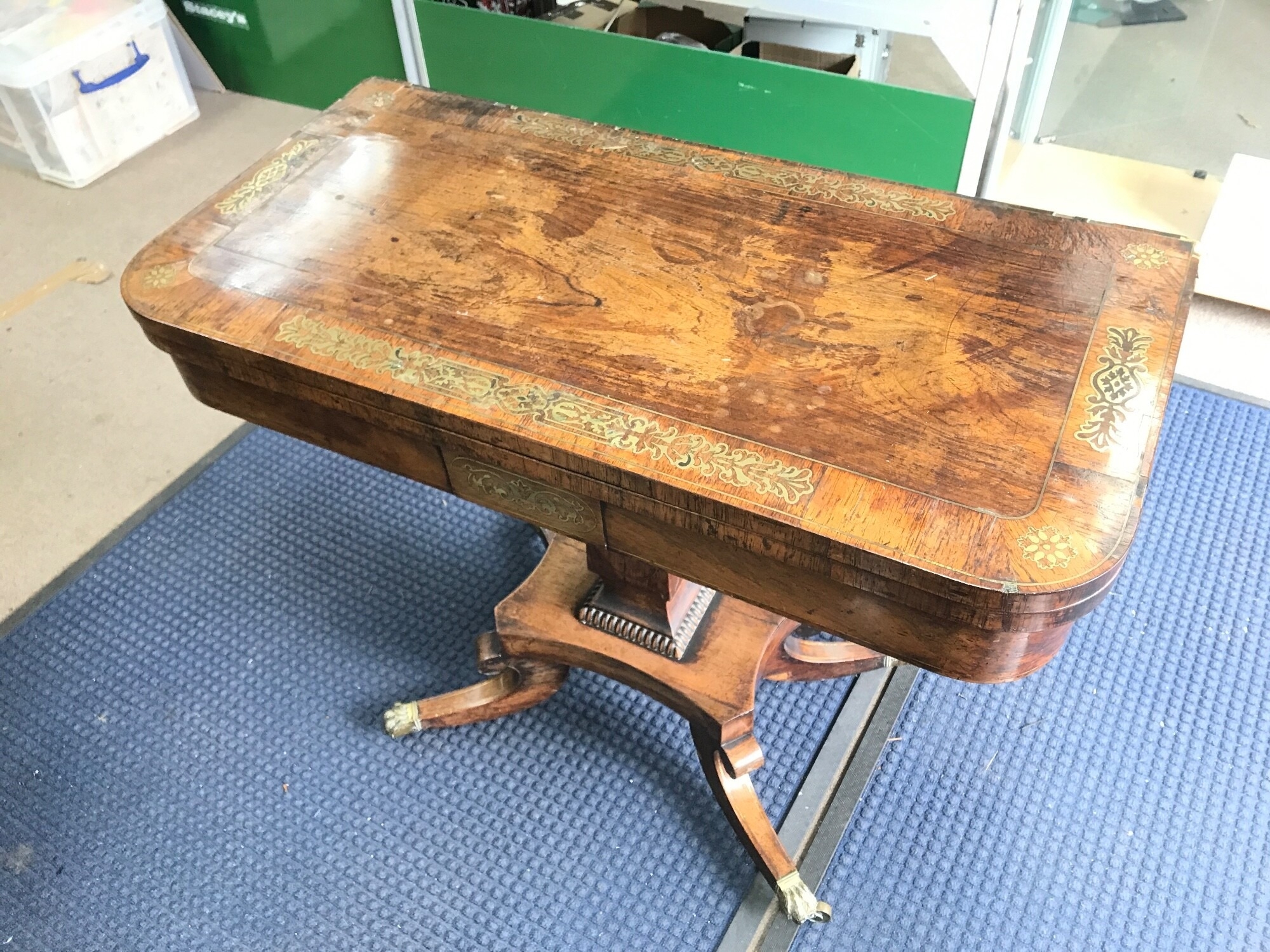 A rosewood veneered card table with brass inlay. In need of restoration. 73cm tall 90cm wide 45cm long