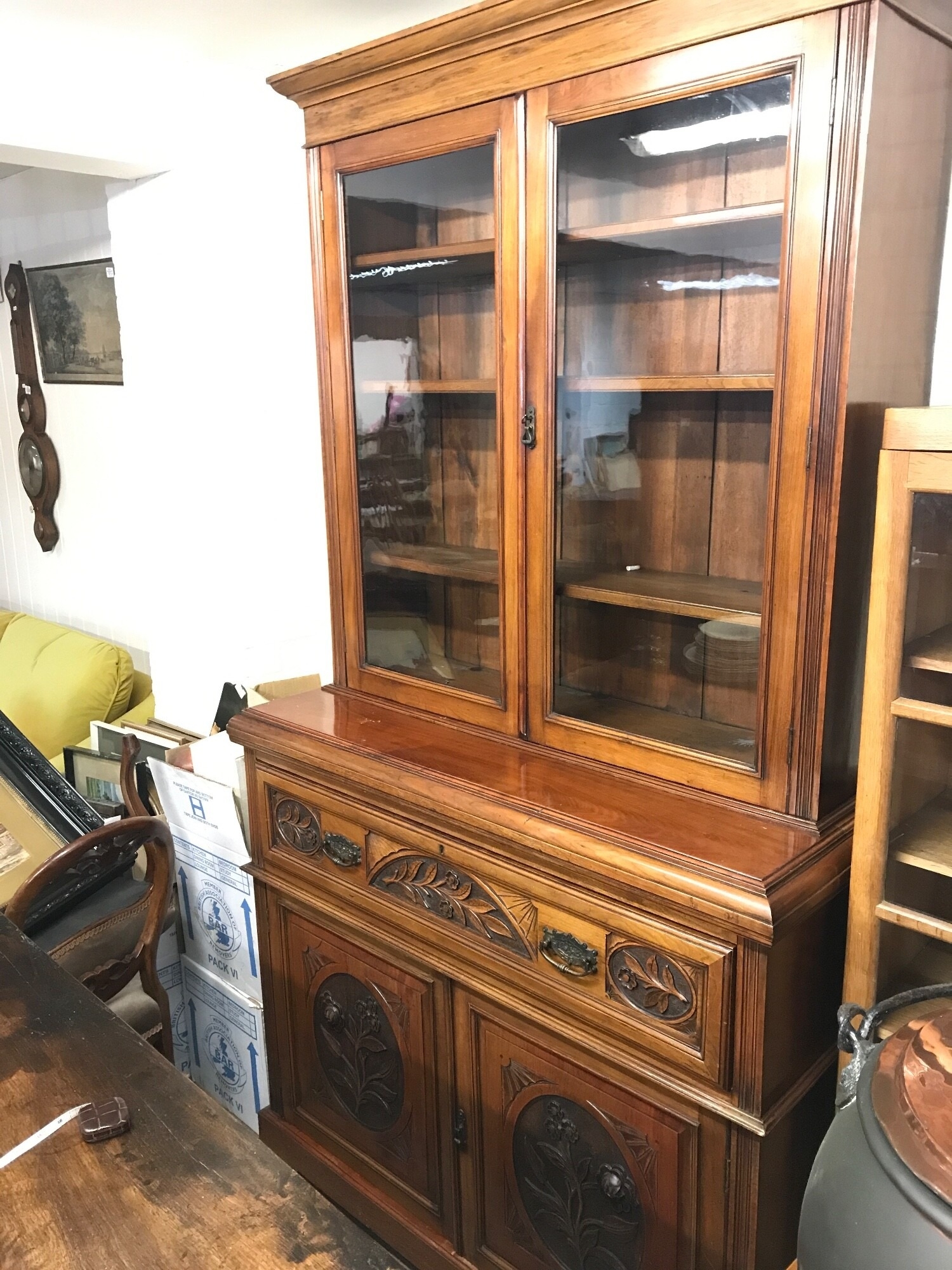 A walnut secretaire bookcase with carved floral design. 221cm tall. 51cm deep, 122cm wide