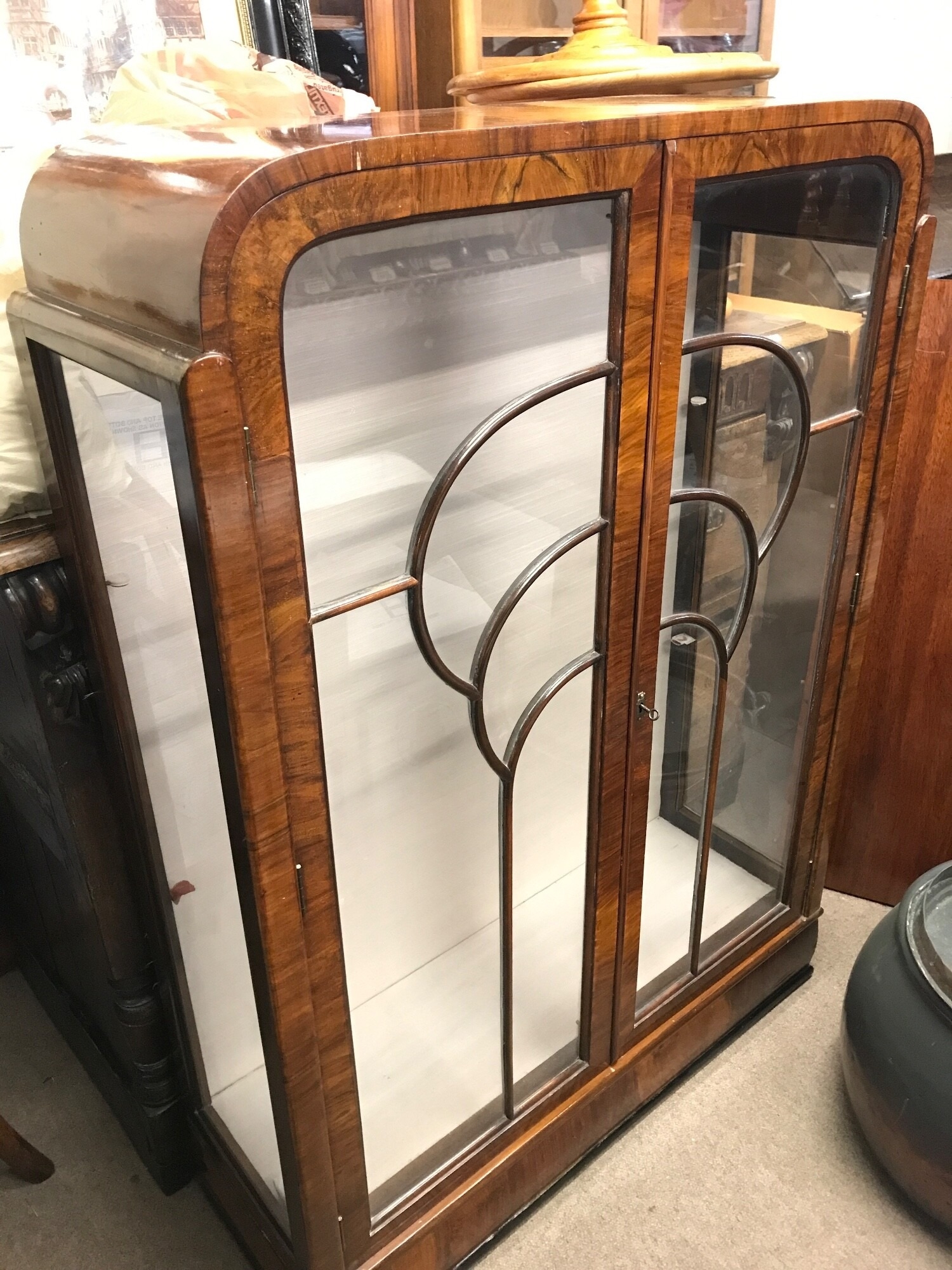 A walnut art deco display cabinet with rounded corners, 86cm wide , 122cm tall, 30cm deep