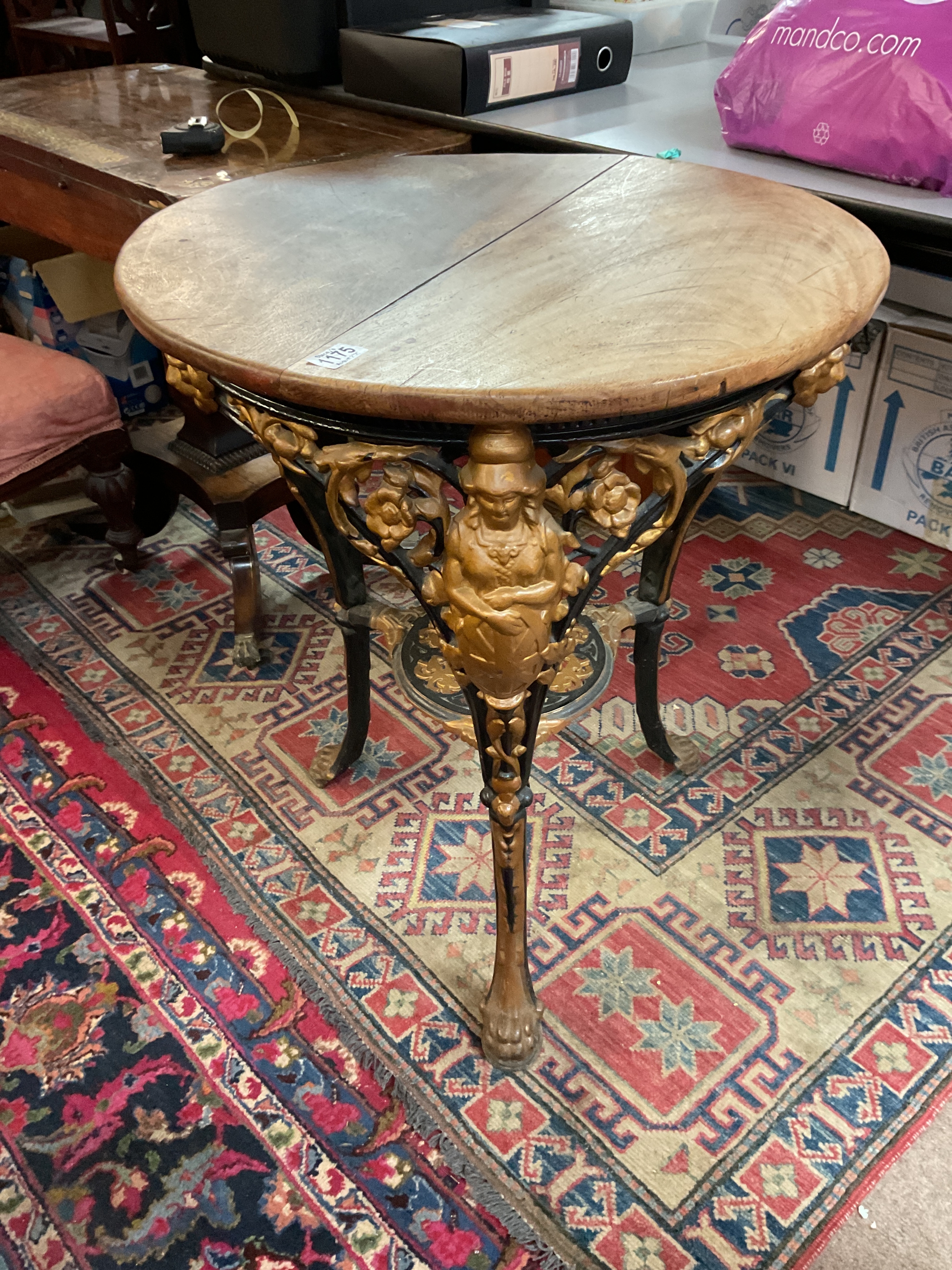 Cast iron three legged gilded on black oak topped pub table .H77cm x W62cm.