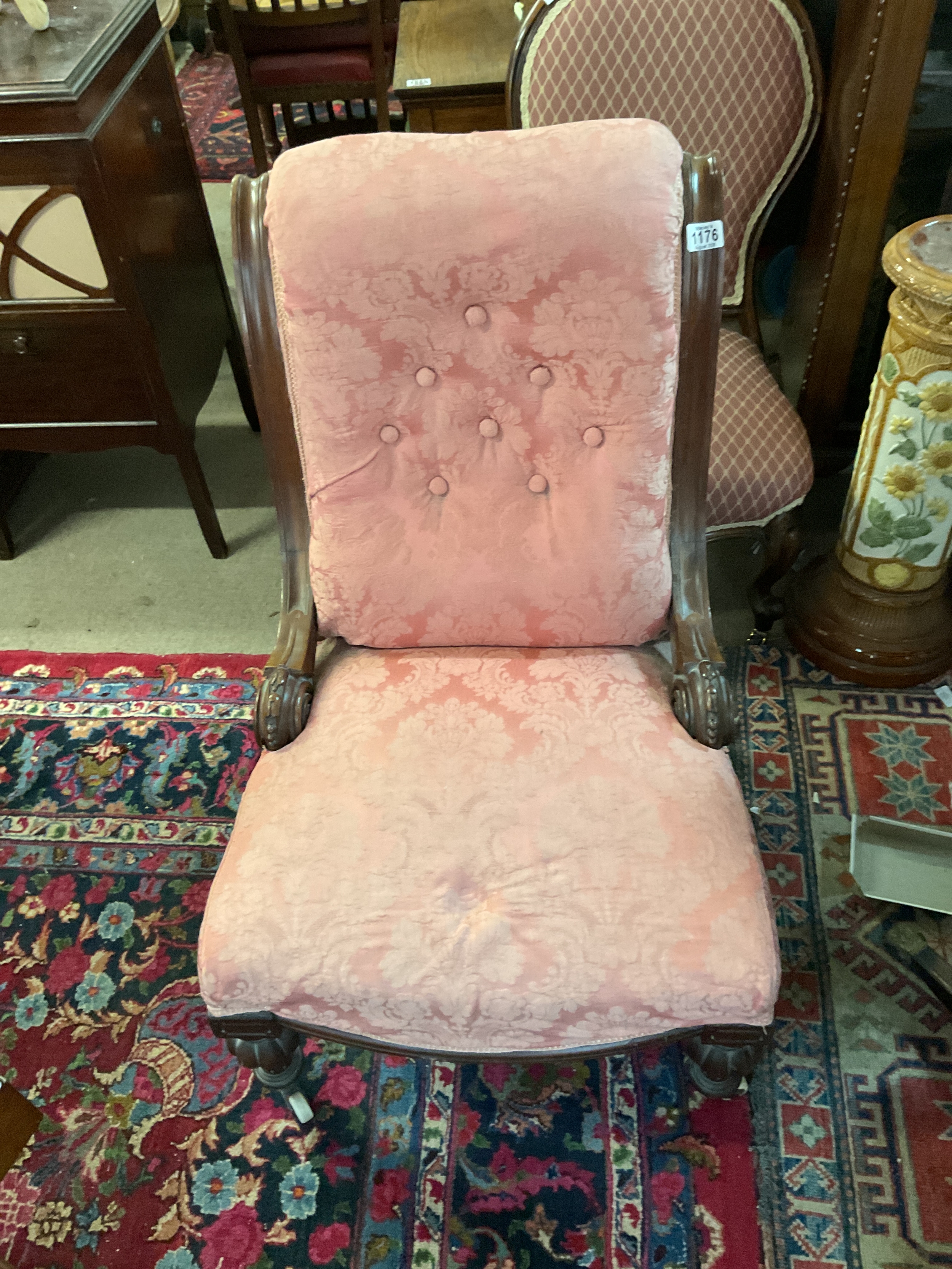 Victorian Mahogany pink button back upholstered nursing chair on ceramic coasters.