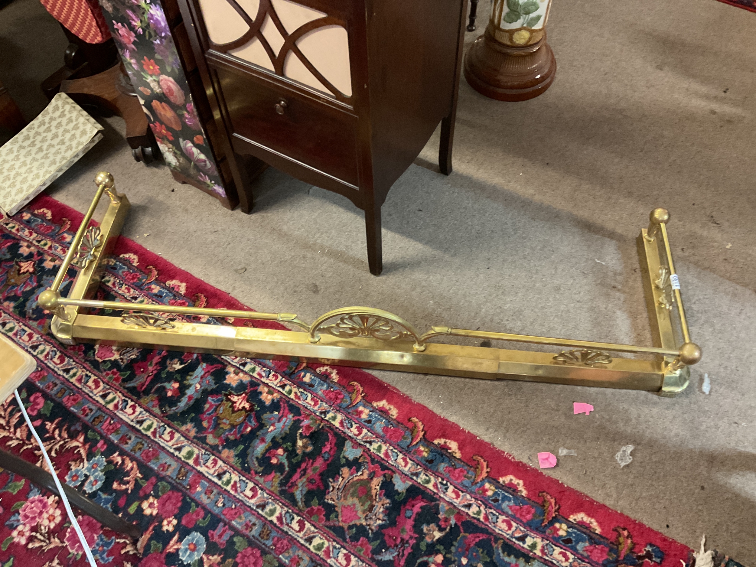 Brass ornate fender.which extends 