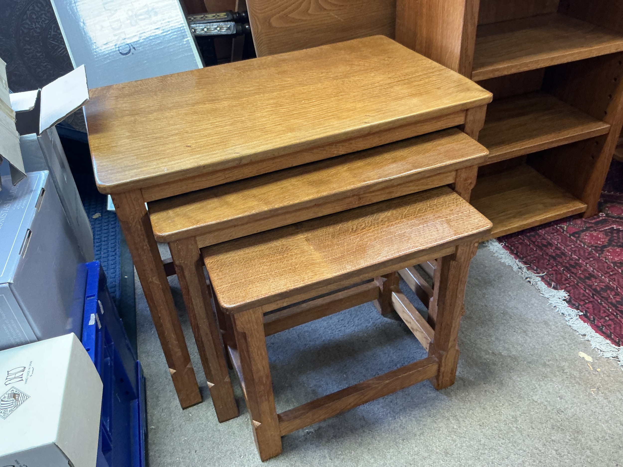 Robert Mouse Man Thompson of Kilburn. A nest of three tables, circa 1970s. Dimensions of largest table 61cm x 37cm x 46.5 cm.