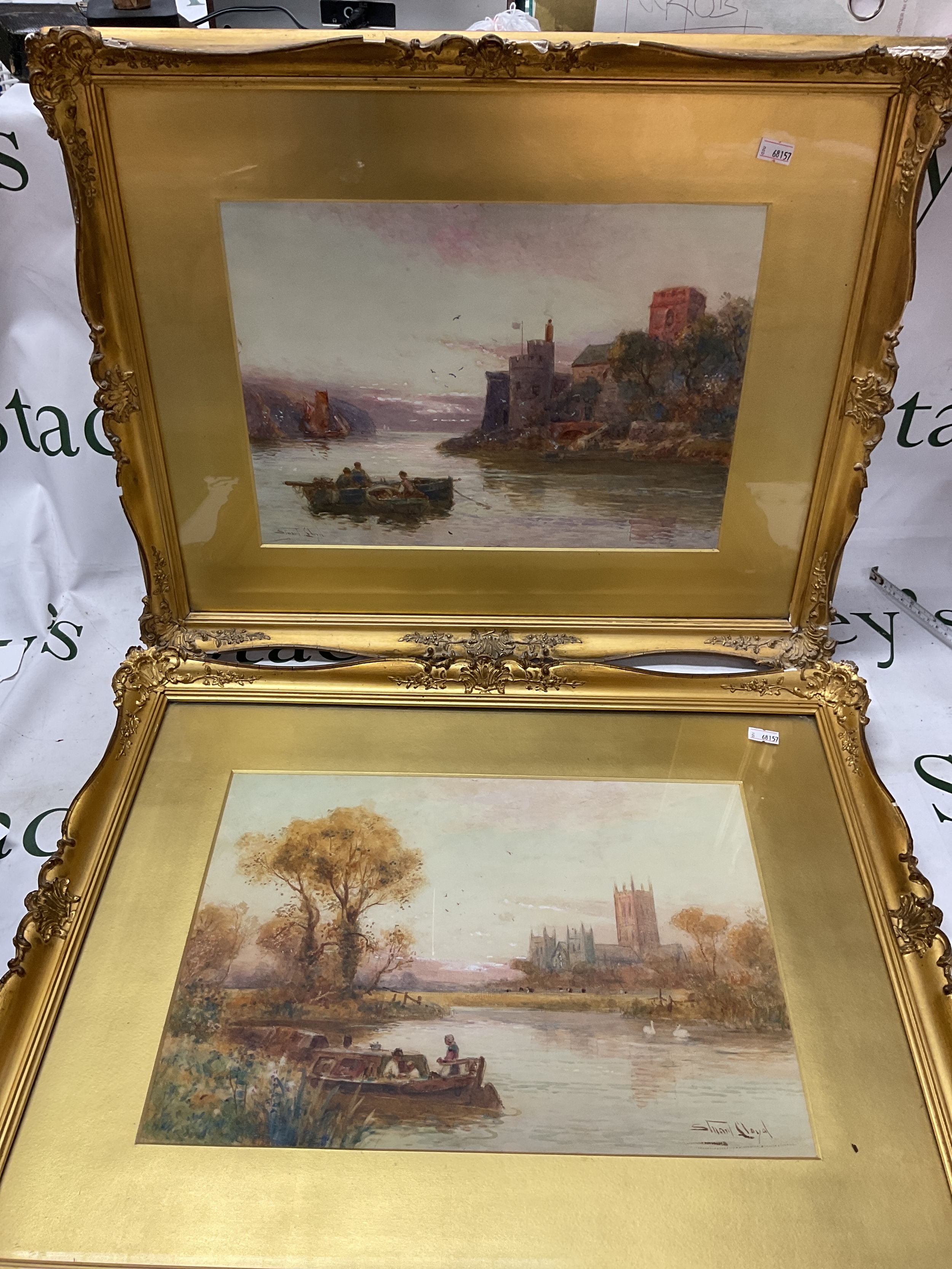 Walter Stuart Lloyd RBA (1858-1926) pair of water colours in gilt frames, one of a small barge with Lincoln Cathedral in the foreground, the other with fisherman in a small boat with coastal castle in foreground possibly Dartmouth. 25 cm x 35 cm.